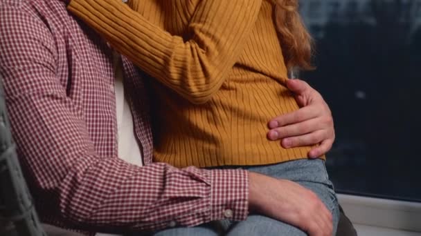 Caucasian man is holding on the knees his red haired wife having a date during the valentines day — Stock Video