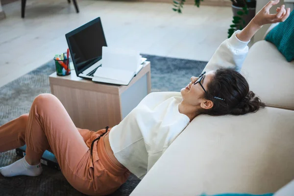 Woman saying yes on the floor after finishing homework. Lucky person. Educational concept photo of a good student.