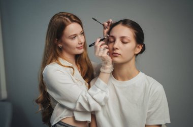 Makyaj Danışmanıyla Stüdyo Güzellik Danışmanlığı Müşterinin Arkasında Duruyor, Göz Şeklini Değerlendiriyor ve