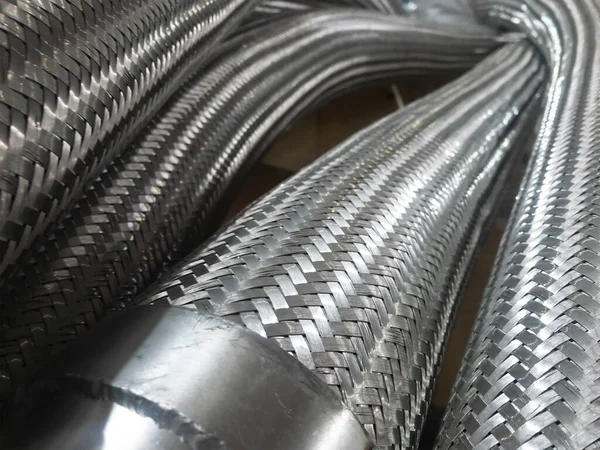 Long metal flexible compensator pipes close up — Stock Photo, Image