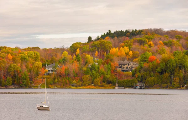 Fall colours along the Gatineau river reflected in water, Quebec, Canada