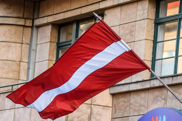 RIGA, LATVIA. 20th November 2020.  Flag of Latvia waves in Riga city.