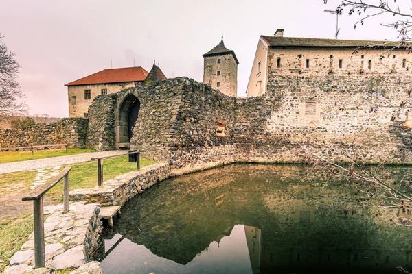 Massive and well fortified medieval Water Castle of Svihov is situated in the Pilsen Region, Czech Republic, Europe. There are water canal around the stone castle. Winter view.