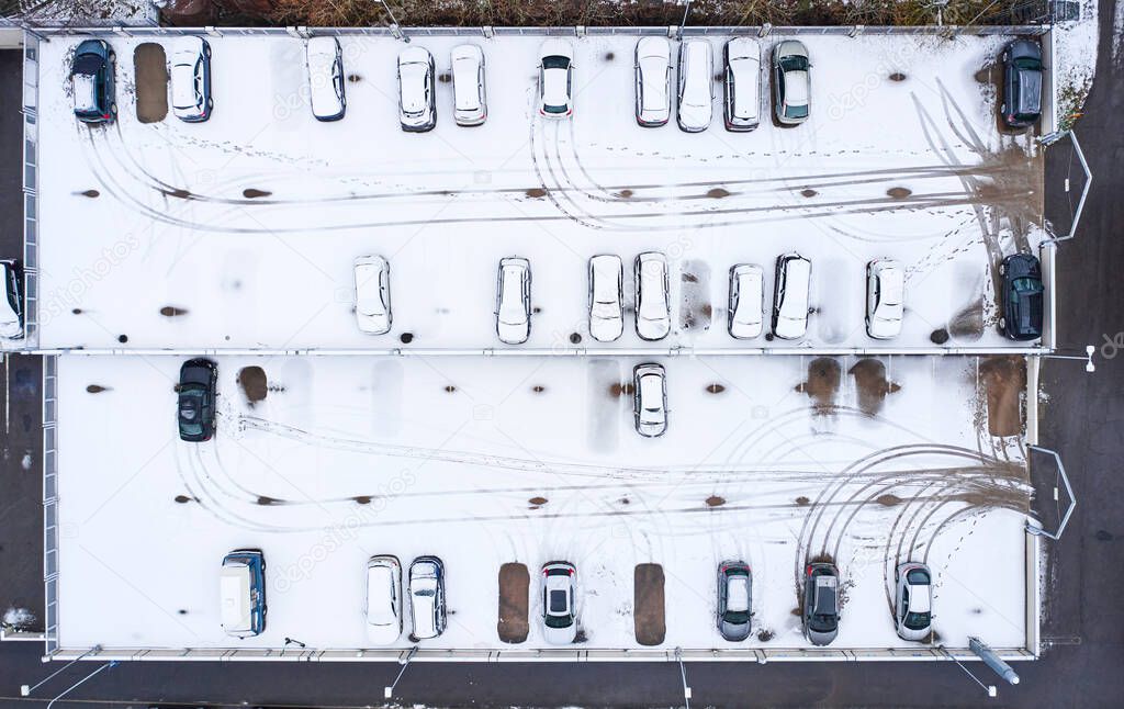 Aerial view of the car parking during the first snowfall this winter.
