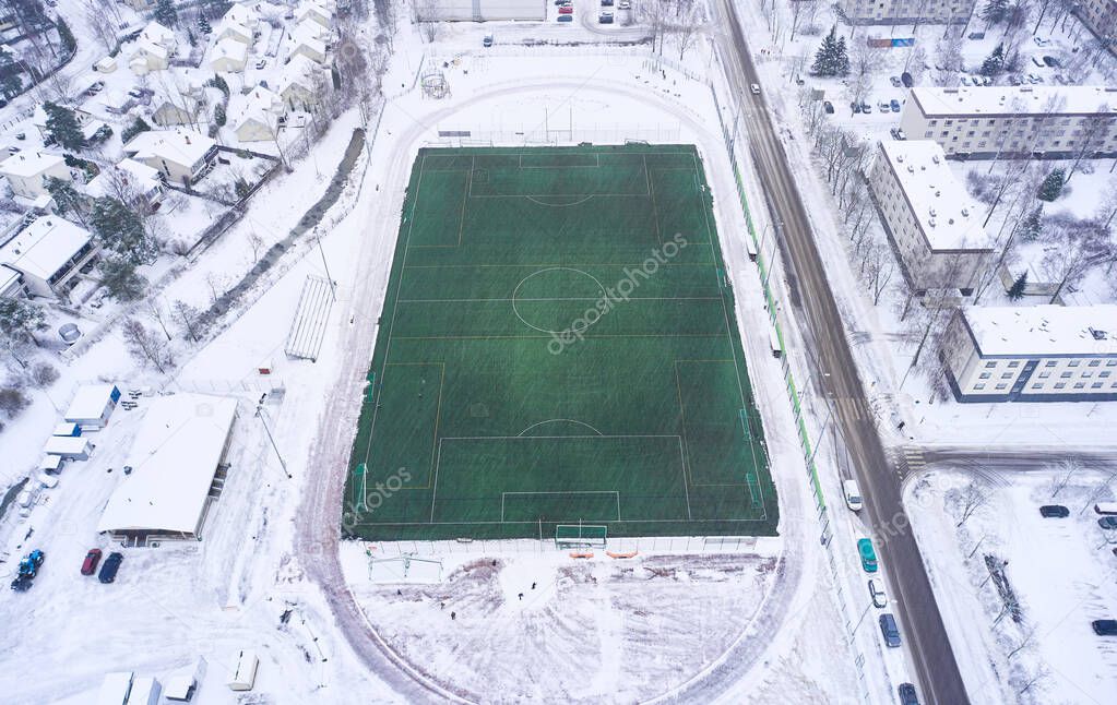 Aerial view of the outdoor football heated field in winter, Finland.