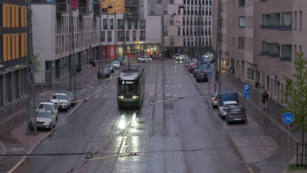 フィンランドのヘルシンキ 2021年5月20日 ジャカサーリ地区の通りの眺め 路面電車が通りを走っている 都市の雨の日 — ストック動画