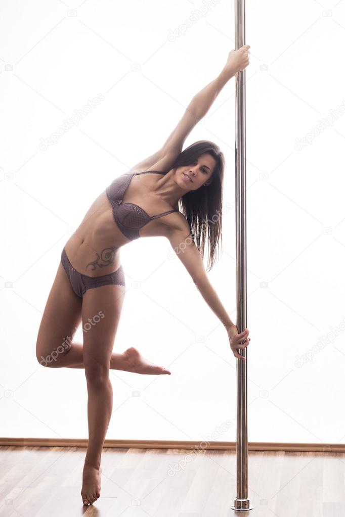 Beautiful young woman exercise pole dance