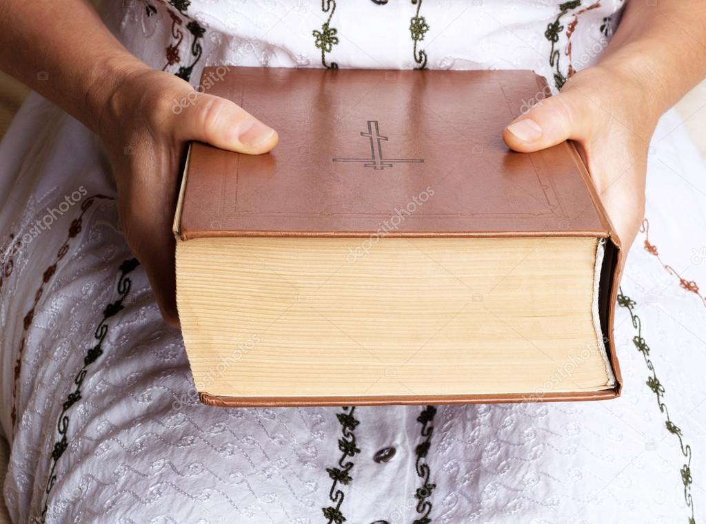 Woman holding Holy Bible
