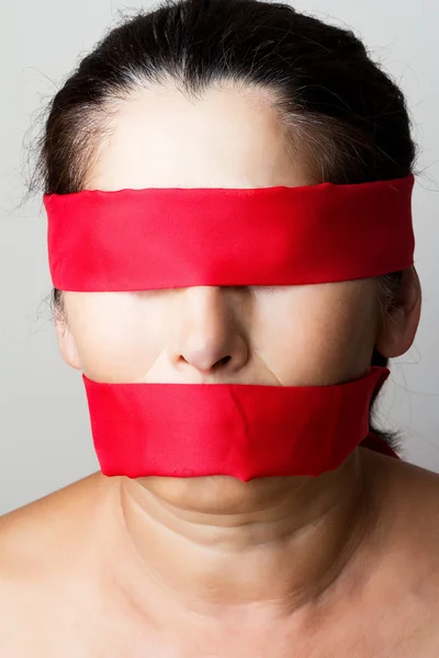 Tied mouth and blindfold eyes. Stock Photo