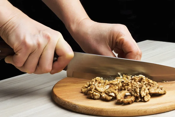 Chopped walnuts with a knife — Stock Photo, Image
