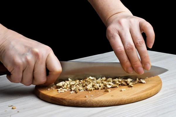 Chopped walnuts with a knife — Stock Photo, Image