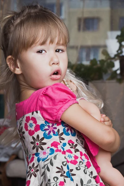 Cheerful little girl with a doll — Stock Photo, Image