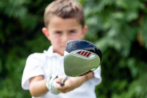 Primer plano de la cabeza del club de golf del conductor sostenido por el golfista niño pequeño - se —  Fotos de Stock