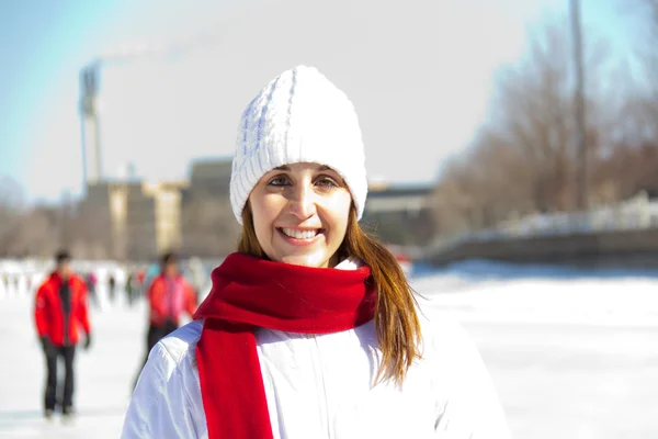 Winter portrait of an attractive woman with a red scarf — Stock Photo, Image