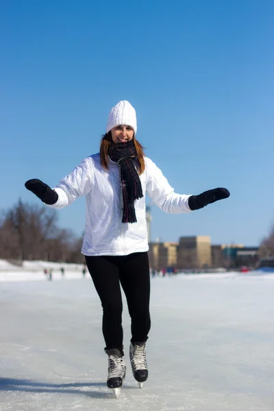 Healthy young woman ice skating during winter — Stock Photo, Image