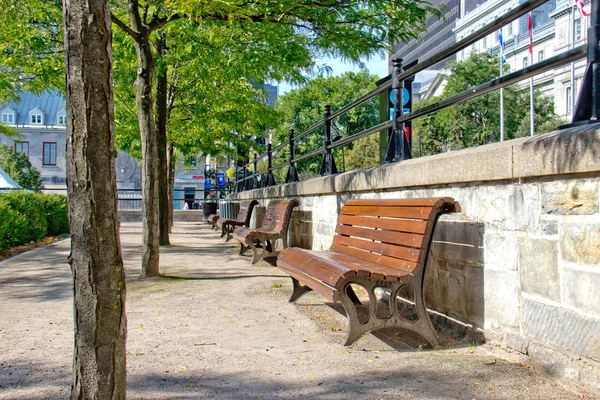 Park bench on a quiet city street — Stock Photo, Image