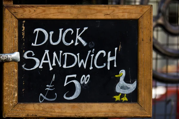 Chalkboard sign at a cafe offering a special on duck sandwich — Stock Photo, Image
