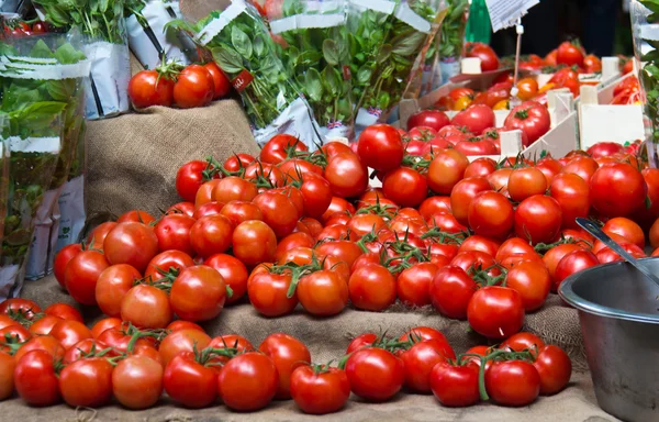 Tomates rojos maduros jugosos para la venta en un mercado de verduras — Foto de Stock