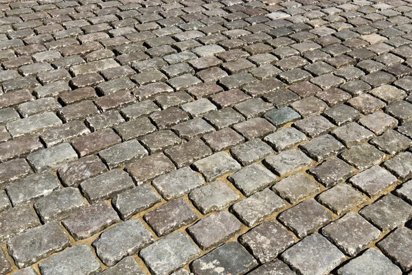 Close-up of cobblestone road - background