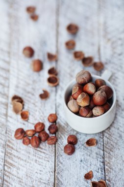 Beyaz bir tablo üzerinde beyaz bir fincan fındık