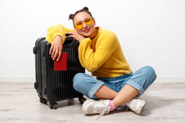 concept of travel. happy woman girl with suitcase and passport.