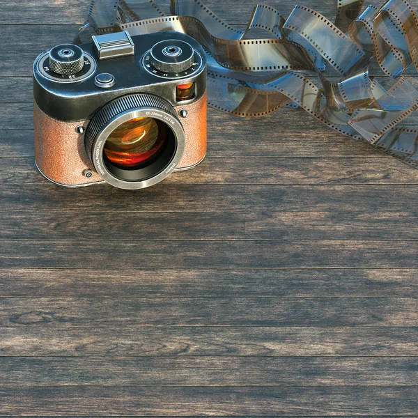 Old style photo camera SLR with vintage photo film strip — Stock Photo, Image