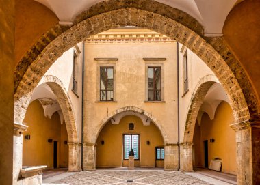 Romanesque-inspired loggia in the quadrangular courtyard of the Palazzo dei Duchi Acquaviva, Atri, Italy clipart