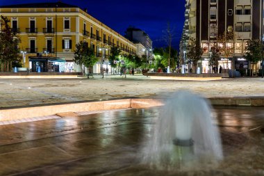 Pescara, İtalya 'da çeşmeleri ve dükkanları olan Piazza del Sacro Cuore' un gece manzarası.