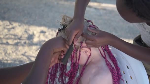 El proceso de tejer trenzas africanas. Las niñas trenzan trenzas afroamericanas. Moda y belleza — Vídeo de stock