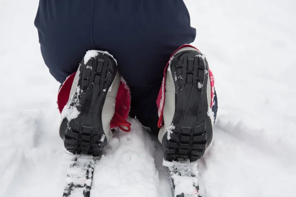 Skier\'s boots close up. Children\'s ski boot sole. Child\'s rest on the ski track.