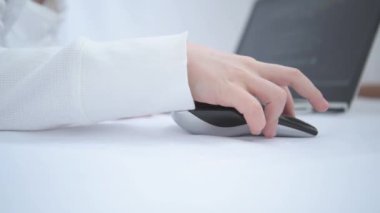 Childrens hand close up. The child is studying or playing on the laptop. Then he gets angry and bangs his fist on the table