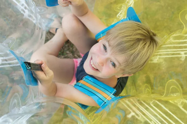 A child in a bumperball. Portrait of a happy laughing child. Happiness, fun and laughter — Stock Photo, Image