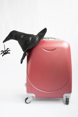 The witchs hat lies on a travel suitcase. Concept. The witch is going on a trip, to the Sabbath, to Halloween. The witch moves or travels. Check in at the hotel, uninvited guest clipart