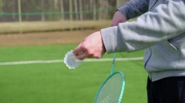 Badminton raketli bir adam. Önümüzde stadyum var. Yaz hobileri, aktiviteler, amatör badminton, spor.