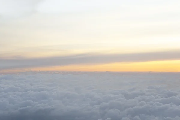 Au-dessus des nuages avec une belle lumière du coucher du soleil — Photo