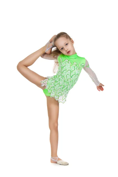 Cute little girl gymnast with a highly raised leg. Vertical splits. — Stock Photo, Image