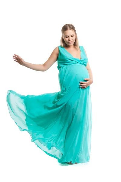 Young pretty pregnant woman. A woman waiting for a child. The joy of motherhood. Light air summer dress, white background. — Stock Photo, Image