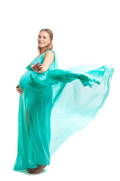 Young pretty pregnant woman. A woman waiting for a child. The joy of motherhood. Light air summer dress, white background. — Stock Photo, Image