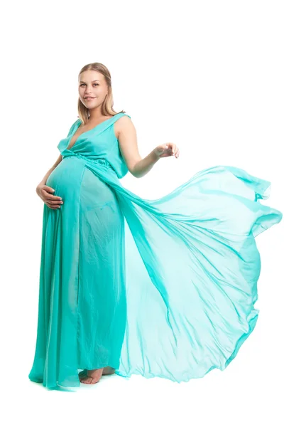 Young pretty pregnant woman. A woman waiting for a child. The joy of motherhood. Light air summer dress, white background. — Stock Photo, Image