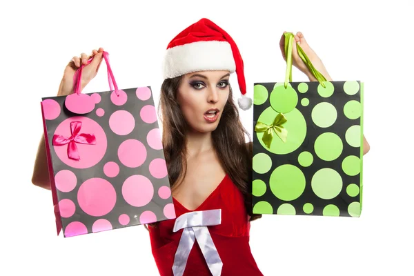 Menina com compras de Natal no chapéu de Papai Noel — Fotografia de Stock