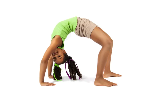 Young baby artistic gymnast doing bridge, isolated — Stock Photo, Image