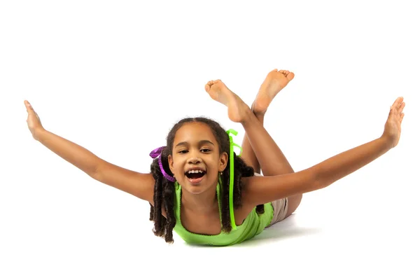 Cheerful little girl is lying on the floor — Stock Photo, Image