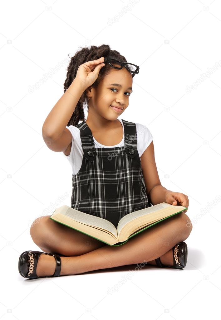 smart girl reading a big green book