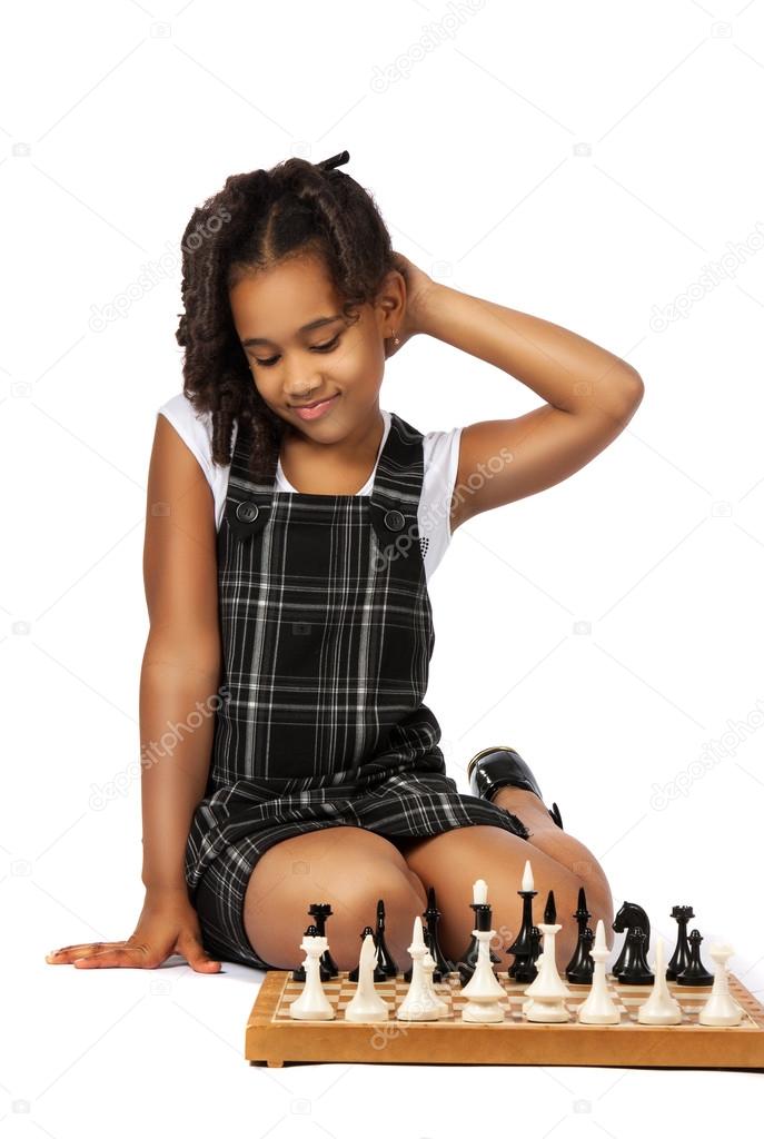Clever girl playing chess thinking