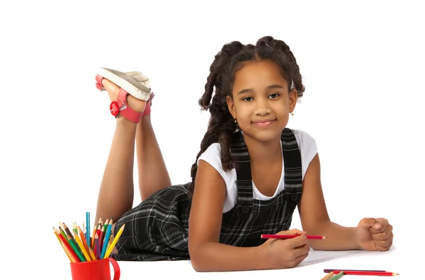 Cheerful girl draws pencil lying on the floor — Stock Photo, Image