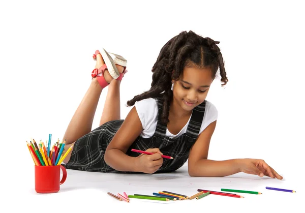 Cheerful girl draws pencil lying on the floor — Stock Photo, Image