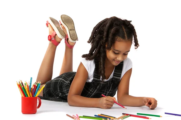 Cheerful girl draws pencil lying on the floor — Stock Photo, Image