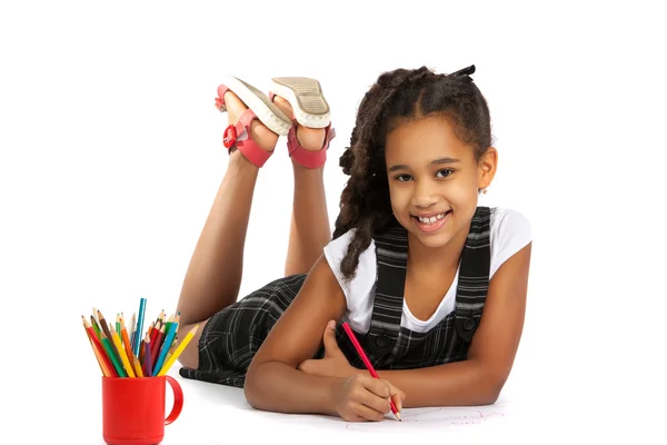 Cheerful girl draws pencil lying on the floor — Stock Photo, Image