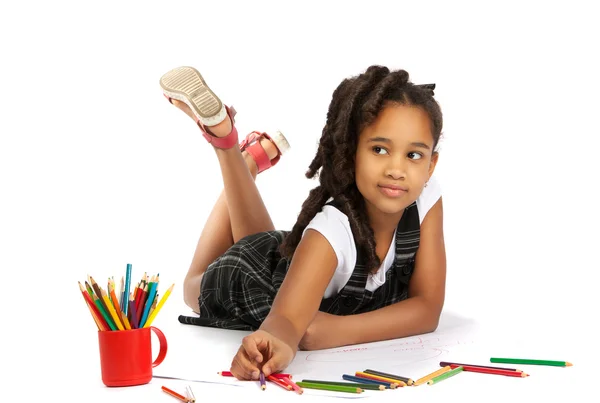 Cheerful girl draws pencil lying on the floor — Stock Photo, Image