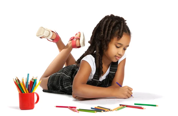 Cheerful girl draws pencil lying on the floor — Stock Photo, Image